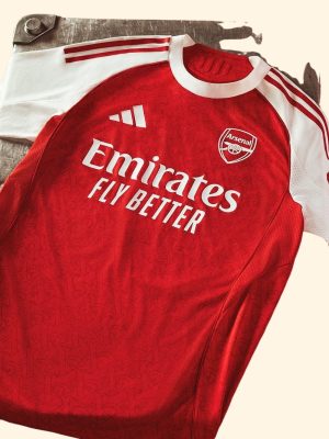 Arsenal players wearing 2025–26 jerseys celebrating a goal