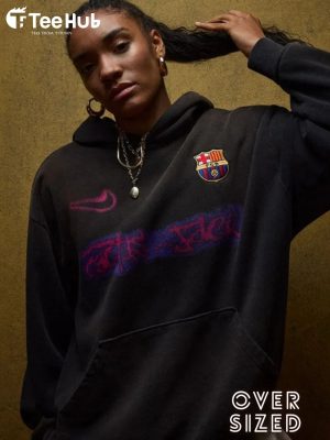 Model wearing oversized Travis Scott Barça hoodie with Camp Nou in background teehub hoodei travis scott