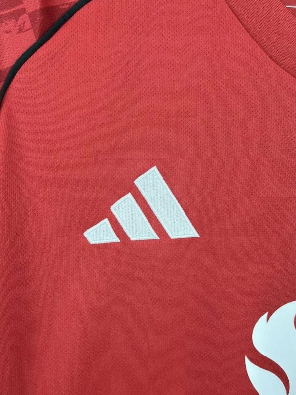 Manchester United players walking out in the 25/26 kit at Old Trafford